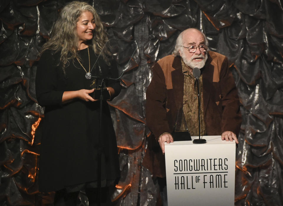 FILE - This June 18, 2015 file photo shows honoree Robert Hunter, right, and Trixie Garcia accepting the award for her father Jerry Garcia at the 46th Annual Songwriters Hall Of Fame Induction and Awards Gala in New York. Hunter, the man behind the poetic and mystical words for many of the Grateful Dead’s finest songs, died Monday, Sept. 23, 2019, at his Northern California home, according to Grateful Dead drummer Mickey Hart. He was 78. (Photo by Evan Agostini/Invision/AP, File)