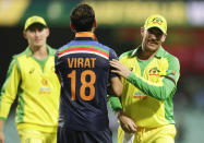 India's Virat Kohli congratulates Australia's Aaron Finch, right, after the one day international cricket match between India and Australia at the Sydney Cricket Ground in Sydney, Australia, Friday, Nov. 27, 2020.Australia defeated India by 66 runs. (AP Photo/Rick Rycroft)