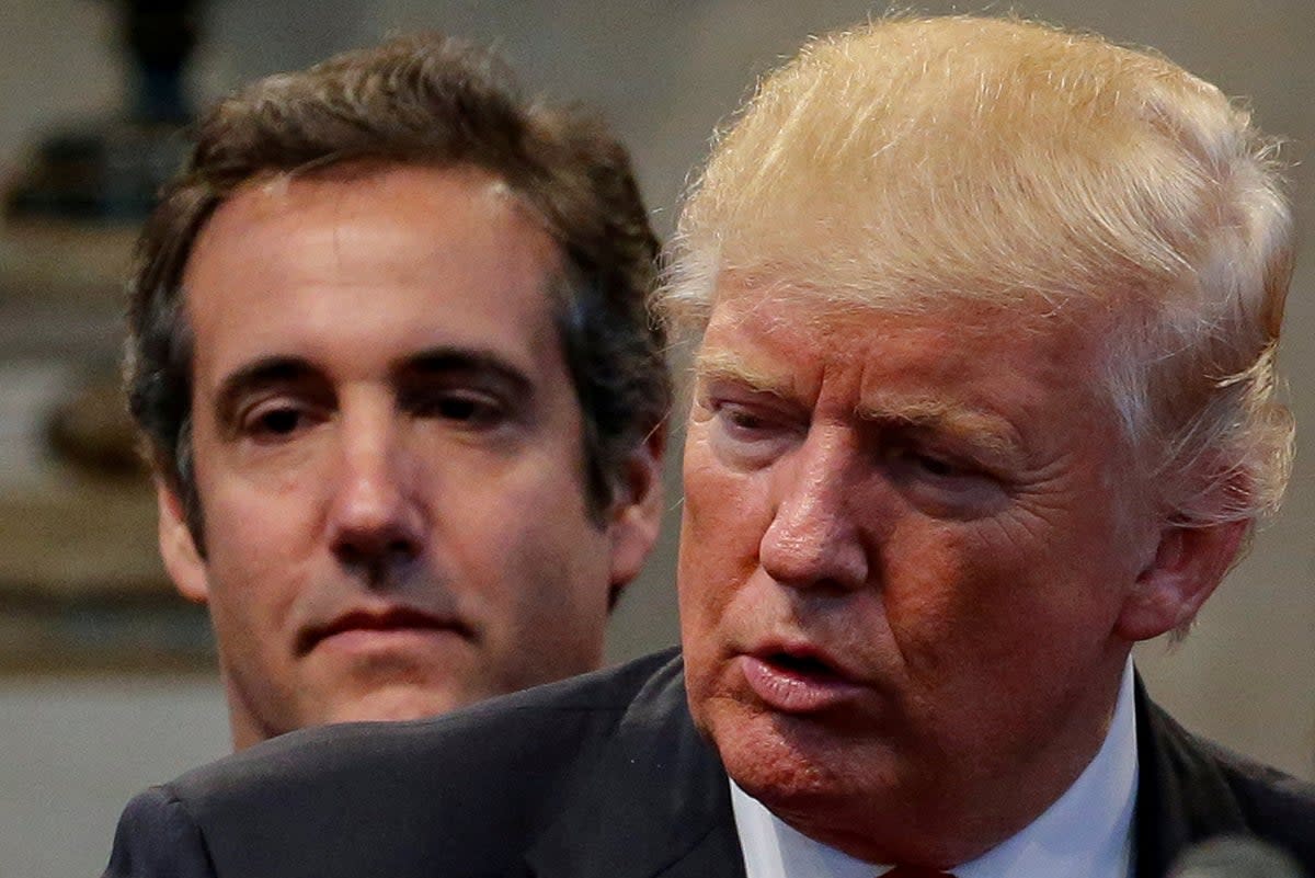 Michael Cohen stands behind Donald Trump at an event in Ohio on 21 September 2016 while the latter was running for president (REUTERS)