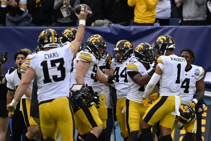 Iowa defensive back Xavier Nwankpa (1) celebrates with teammates after intercepting pass for a touchdown against Kentucky in the first half of the Music City Bowl NCAA college football game Saturday, Dec. 31, 2022, in Nashville, Tenn. (AP Photo/Mark Zaleski)
