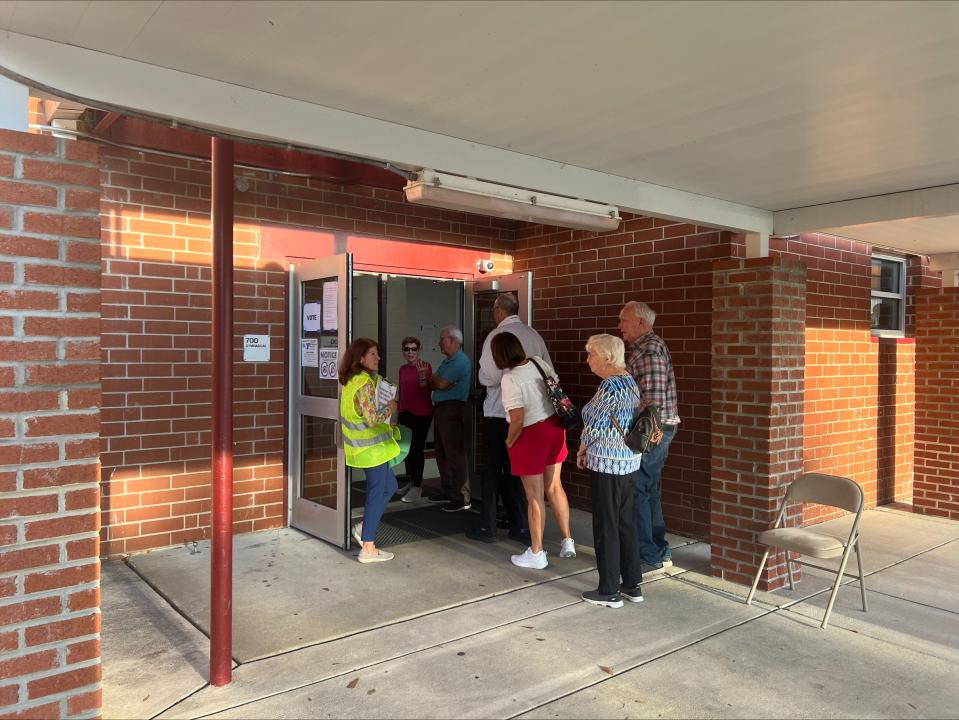 A line forms outside the polls at Lincoln Elementary School in Leland shortly after 5 p.m. on Tuesday.