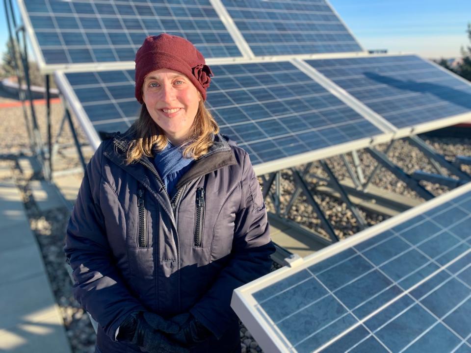 Heather MacKenzie, executive director of Solar Alberta, checks out the solar array on the roof of Northern Alberta Institute of Technology in Edmonton.