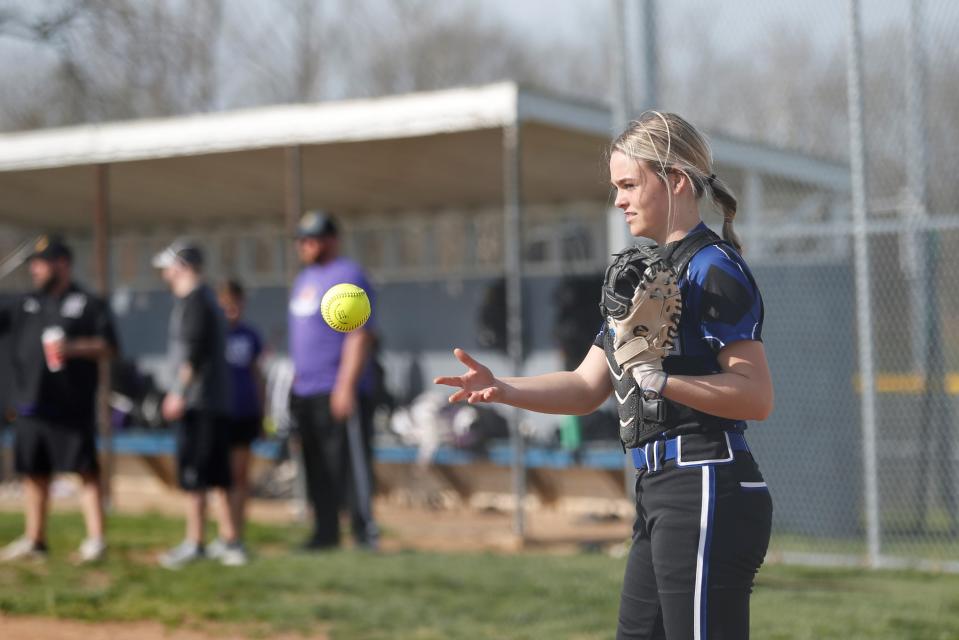 Centerville sophomore Drew Tubesing tosses the ball to her coach before a Wayne County Tournament game April 23, 2022.