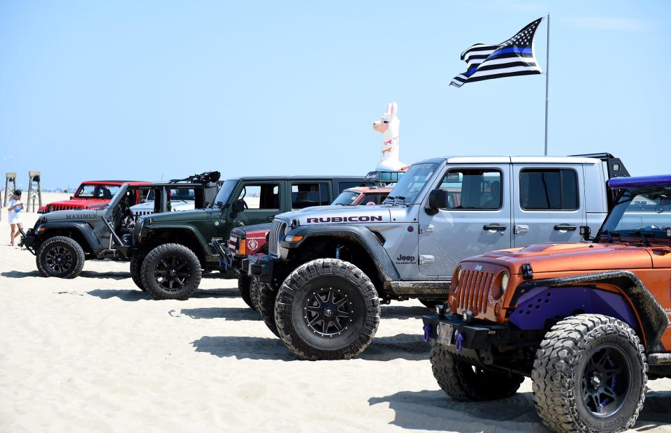 Jeeps are lined up in front of the KICKER sand course during Jeep Week Thursday, Aug. 26, 2021, on the beach in Ocean City, Maryland.