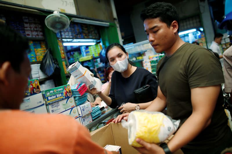 People shop for masks at a whole-sale market for medical stuffs, following the outbreak of the new coronavirus in China, in Jakarta