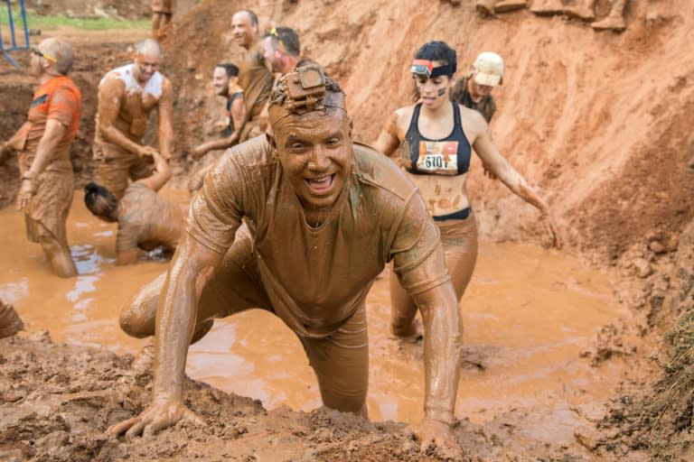 Contestants take part in the Mud Day race, a 13- kilometre (eight-mile) obstacle course, on March 24, 2017 in the Israeli city of Tel Aviv