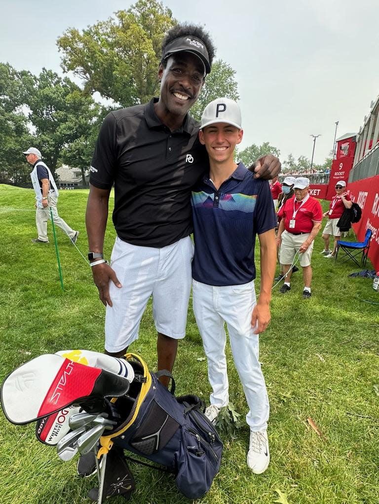 Port Huron Northern's Luke Maher (right) poses for a photo with basketball legend Chris Webber during the pro-am of the Rocket Mortgage Classic at Detroit Golf Club on Wednesday. Maher and Webber were on the same team.