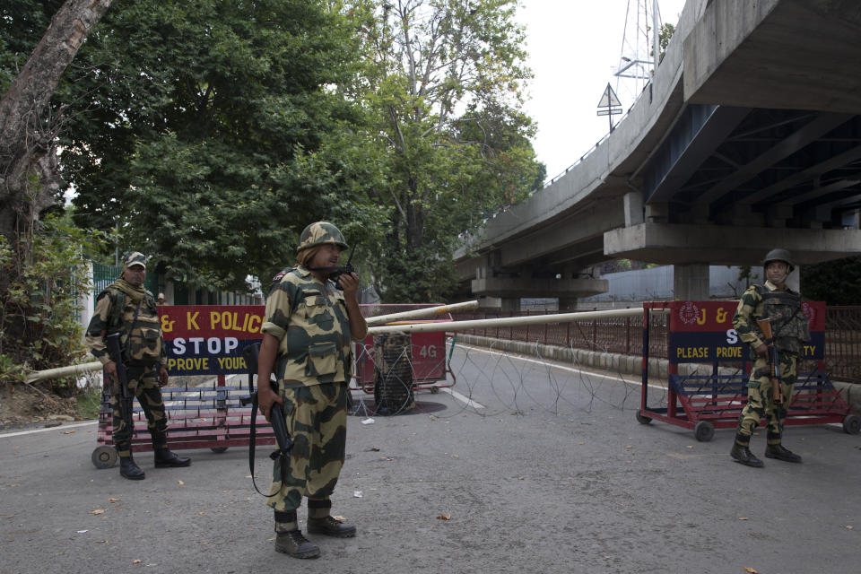 Border Security Force soldiers stand guard at a temporary check post during curfew in Srinagar, Indian controlled Kashmir, Wednesday, Aug. 7, 2019. Authorities in Hindu-majority India clamped a complete shutdown on Kashmir as they scrapped the Muslim-majority state's special status, including exclusive hereditary rights and a separate constitution, and divided it into two territories. (AP Photo/Dar Yasin)