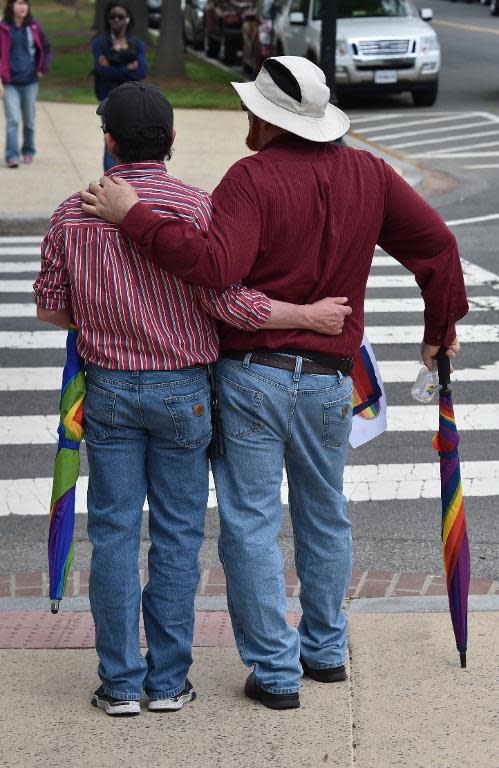 A gay couple leaves after protesting outside the US Supreme Court on April 28, 2014 in Washington, DC