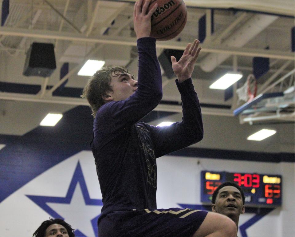 Sacred Heart-Griffin's Will Hamilton goes up for a layup against host Decatur MacArthur during the second half of the Class 3A sectional final on Friday, March 3, 2023.