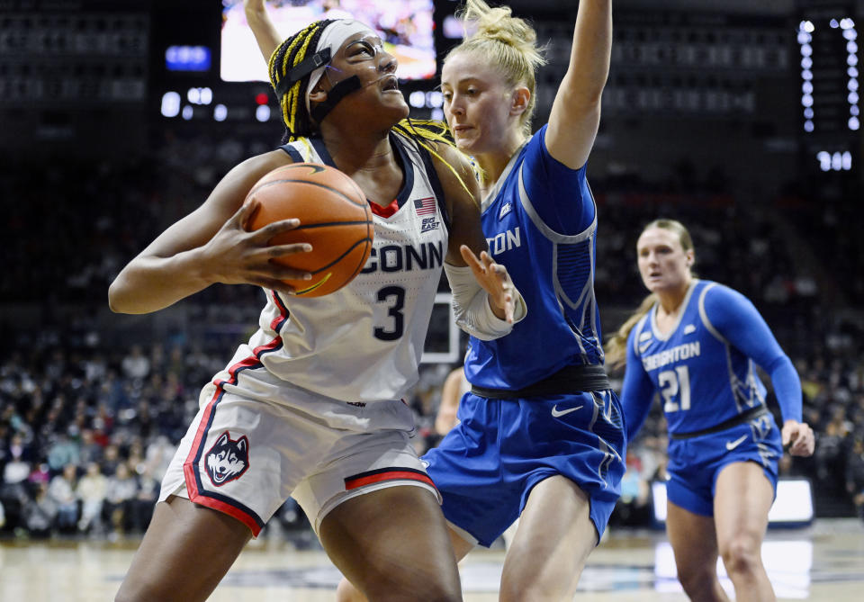 UConn's Aaliyah Edwards, left, looks to shoot as Creighton's Mallory Brake defends during the first half of an NCAA college basketball game Wednesday, Feb. 15, 2023, in Storrs, Conn. (AP Photo/Jessica Hill)