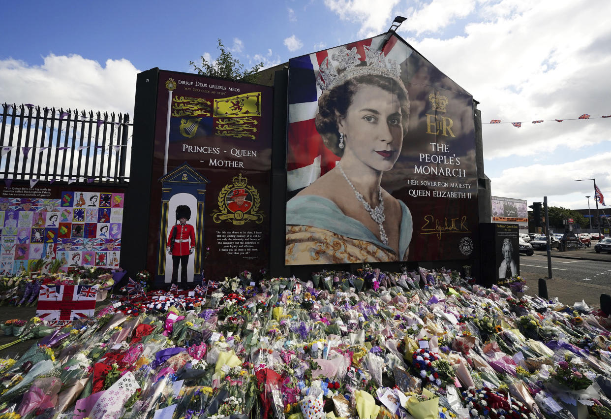 Flowers are laid on Belfast's Shankill Road, Saturday, Sept. 10, 2022, following the death of Queen Elizabeth II on Thursday. (Brian Lawless/PA via AP)