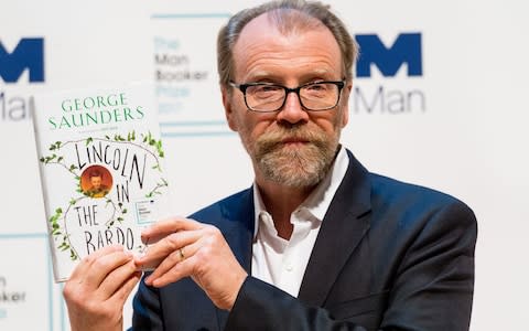 George Saunders with a copy of his Man Booker Prize-winning novel - Credit: Barcroft Media
