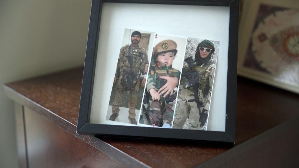 A frame in Sima Gul's living room, shows a collage of images. Gul, right,  in her Afghan military uniform, and her husband in his, left, with their son, center in Blacksburg, Va. Gul met her husband while serving with the Afghan Female Tactical Platoon. He was killed during a battle with the Taliban shortly after they were married and when she was pregnant with their son. (Heather Rousseau/The Roanoke Times via AP)