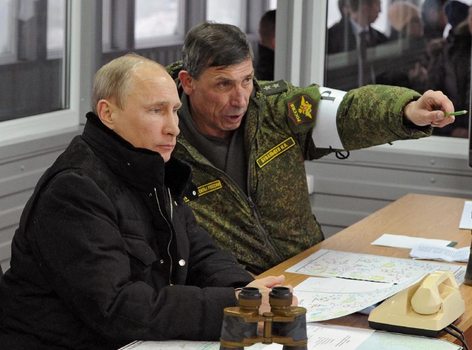 Russian President Vladimir Putin, listens to Gen. Ivan Buvaltsev, right, as they observe a military exercise near St. Petersburg, Russia, Monday, March 3, 2014. pro-Russian troops held all Ukrainian border posts Monday in Crimea, as well as all military facilities and a key ferry terminal, cementing their stranglehold on the strategic Ukrainian peninsula. (AP Photo/RIA-Novosti, Mikhail Klimentyev, Presidential Press Service)