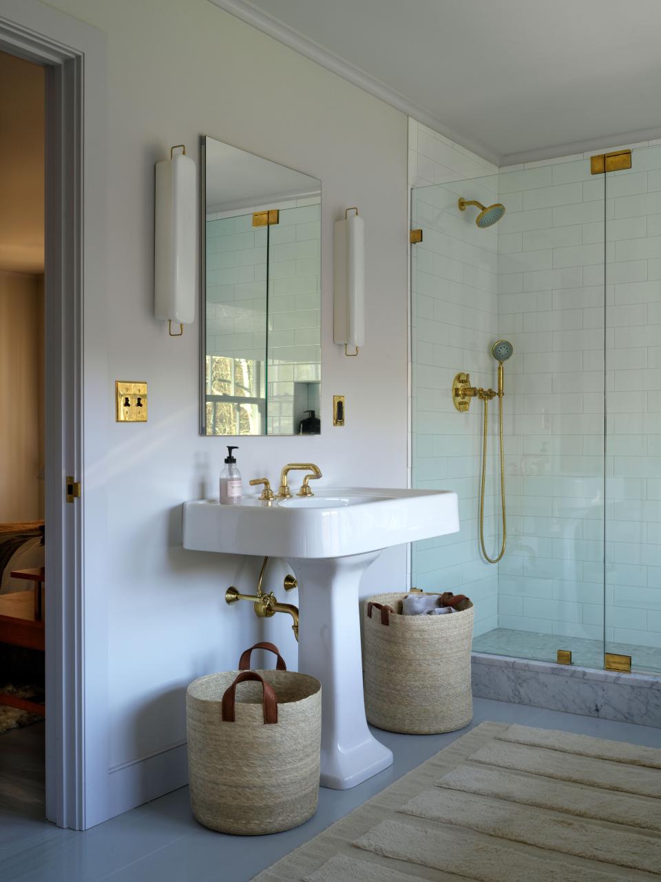 Workstead sconces flank the couple’s vanity.