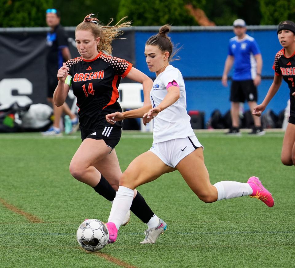 Oregon's Delaney Hoelker (14) rushes to defend Whitefish Bay's Elyse Leinweber (3) during the first half of the Division 2 soccer finals on Saturday.