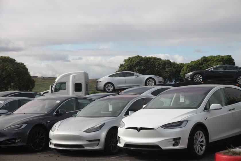 Teslas stack up at a delivery center in Fremont, March 24.