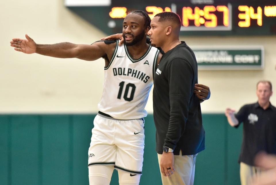 Jacksonville Dolphins guard Gyasi Powell (10) talks with head coach Jordan Mincy during a break in the action against UNF on Feb. 23.