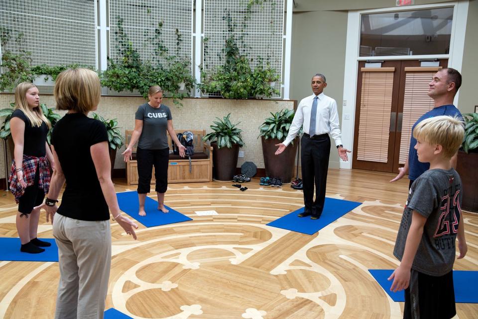 While visiting service members receiving therapy at the Walter Reed National Military Medical Center, Obama joins Master Chief Petty Officer David Halland and his family in a yoga therapy session at the National Intrepid Center of Excellence on Aug. 26.