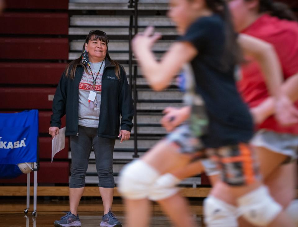 After a day of teaching kindergarten, Shari Daniels encourages her athletes as they run drills during volleyball practice.