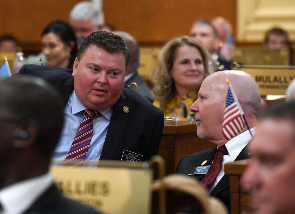 S.D. Representatives Chris Karr and Jim Mehlhaff chat during the first day of legislative session on Tuesday, January 10, 2023, at the South Dakota State Capitol in Pierre.