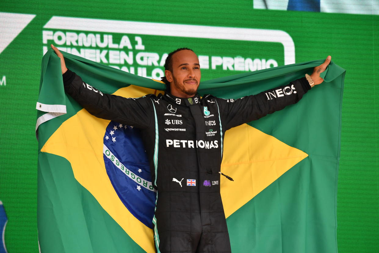 Lewis Hamilton celebrates on the podium after winning Brazil's Formula One Sao Paulo Grand Prix.