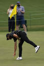 Tommy Fleetwood, of England, picks his ball out of the cup after a hole-in-one on the 16th hole during the first round of the Masters golf tournament on Thursday, April 8, 2021, in Augusta, Ga. (AP Photo/Gregory Bull)