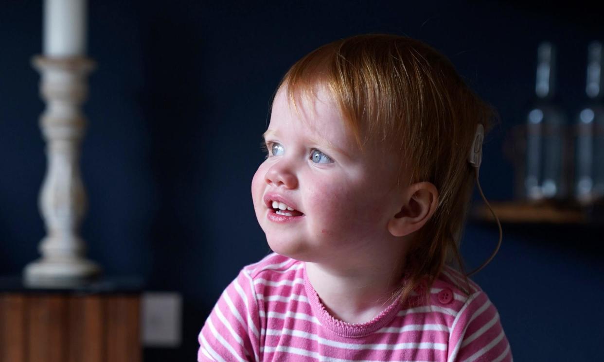 <span>Opal Sandy, who was born completely deaf because of a rare genetic condition, can now hear unaided for the first time.</span><span>Photograph: Andrew Matthews/PA</span>