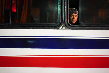 A migrants, part of a caravan of thousands traveling from Central America en route to the United States, sits inside a coach on the outskirts of Guadalajara, Mexico November 13, 2018. REUTERS/Go Nakamura