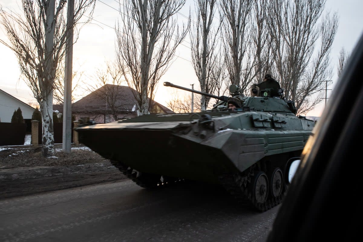 Ukrainian servicemen drive along a street with BMP-2 infantry fighting vehicle in the frontline town of Bakhmut in February 2023 (Yevhenii Zavhorodnii/Reuters)