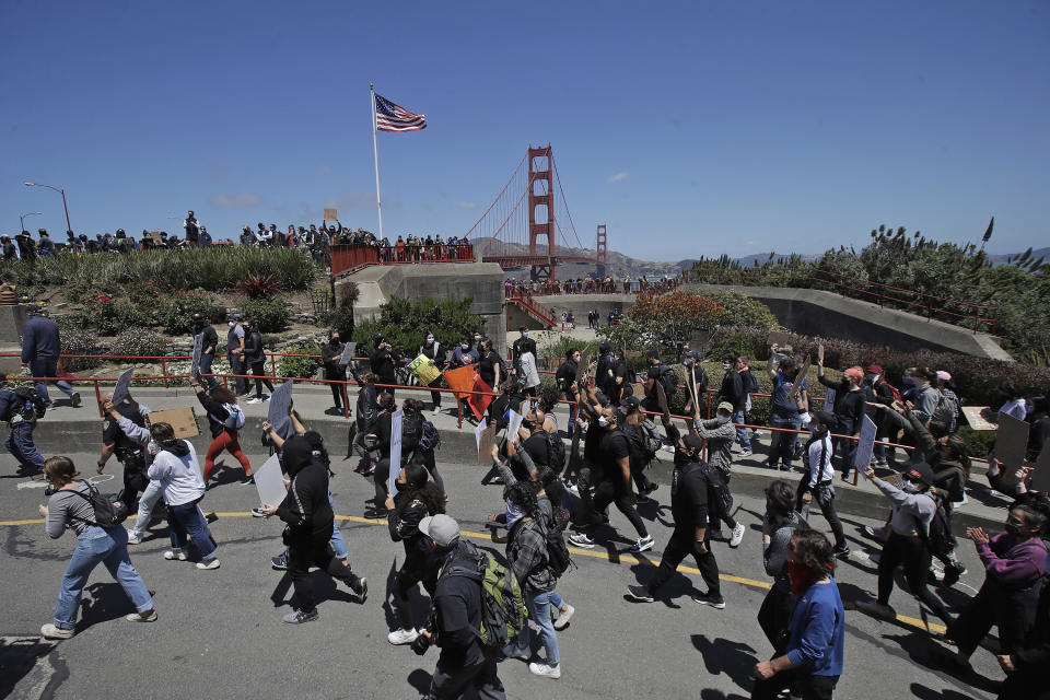 Marchers walk to the Golden Gate Bridge in San Francisco, Saturday, June 6, 2020, at a protest over the Memorial Day death of George Floyd. Floyd died May 25 after being restrained by Minneapolis police. (AP Photo/Jeff Chiu)