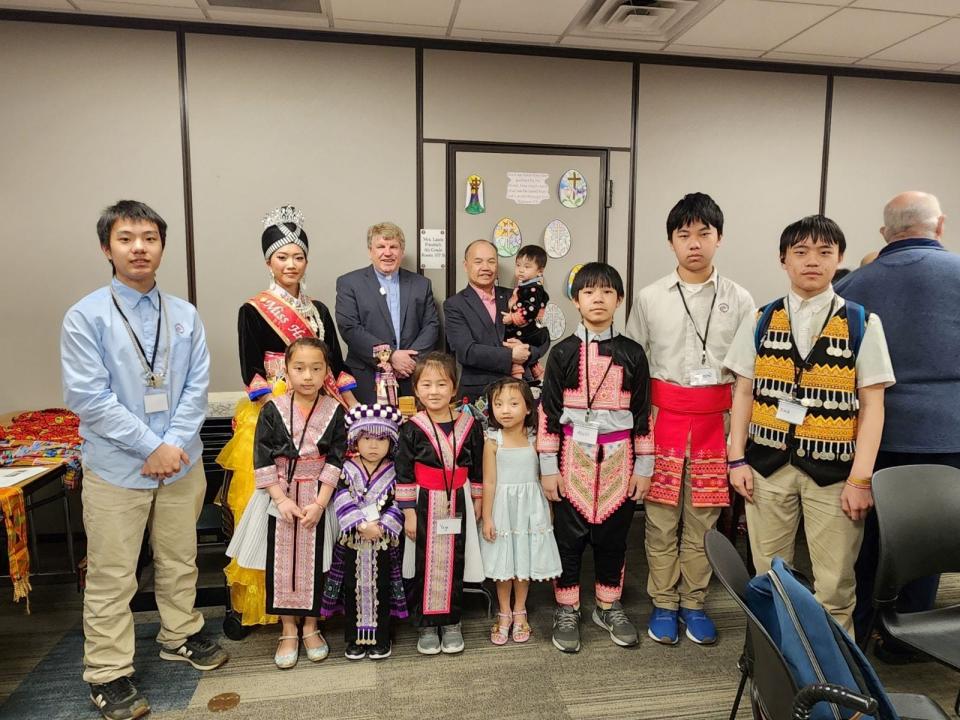 Benediction Lutheran Church pastors Don Hougard and Moua Vang, back left and right, pose for a photo at a multicultural event this spring. The church added a Hmong ministry in 2003 after noticing a growing population of Hmong in the surrounding neighborhood.