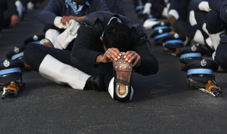 An Indian Air Force soldier stretches during a break in between practice for the upcoming Republic Day parade in New Delhi, India, Thursday, Jan. 21, 2021. Republic Day marks the anniversary of the adoption of the country's constitution on Jan. 26, 1950. Thousands congregate on Rajpath, a ceremonial boulevard in New Delhi, to watch a flamboyant display of the country’s military power and cultural diversity. (AP Photo/Manish Swarup)