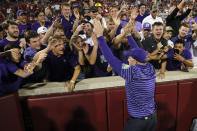 Kansas State coach Chris Klieman celebrates with fans after the team's 41-34 win over Oklahoma in an NCAA college football game Saturday, Sept. 24, 2022, in Norman, Okla. (AP Photo/Nate Billings)