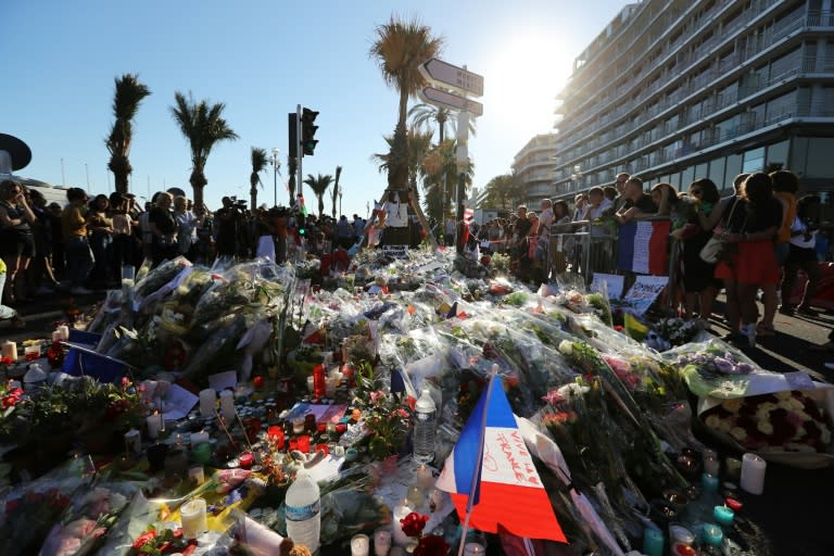 Members of the public gather at a make-shift memorial for victims of the deadly Bastille Day attack on July 16, 2016 in Nice