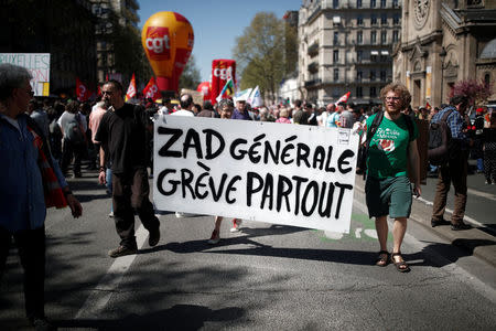 Protestors hold a banner which reads "General ZAD, strike everywhere" during a demonstration against the French government's reform plans in Paris as part of a national day of protest, France, April 19, 2018. REUTERS/Benoit Tessier