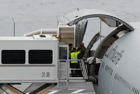 An injured German tourist involved in a bus accident is helped onto a German Air Force medical airplane at Cristiano Ronaldo Airport in Funchal, on the island of Madeira, Portugal April 20, 2019. REUTERS/Rafael Marchante