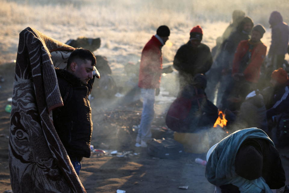 Refugees brave the cold in a frozen field after they fled from Ukraine because of the Russian invasion at the border checkpoint in Medyka, Poland, March 1, 2022.   REUTERS/Kai Pfaffenbach