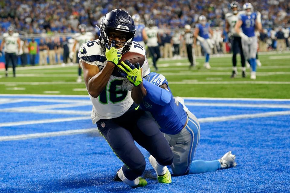 Seattle Seahawks wide receiver Tyler Lockett (16) catches a 3-yard touchdown pass in front of Detroit Lions cornerback Jerry Jacobs during the second half of an NFL football game, Sunday, Sept. 17, 2023, in Detroit. (AP Photo/Paul Sancya)