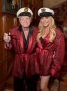 <p>Hugh Hefner opted for black pyjamas and a red robe for the Playboy Mansion’s Annual Halloween Bash in October, 2014. Here, he is pictured with Crystal Hefner. [<em>Photo: Getty]</em> </p>