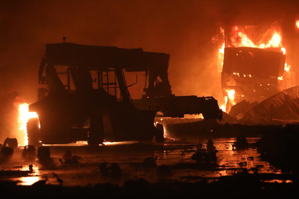 A fire rages at the BM Inland Container Depot, a Dutch-Bangladesh joint venture, in Chittagong, 216 kilometers (134 miles) southeast of capital, Dhaka, Bangladesh, early Sunday, June 5, 2022. Several people were killed and more than 100 others were injured in the fire the cause of which could not be immediately determined. (AP Photo)