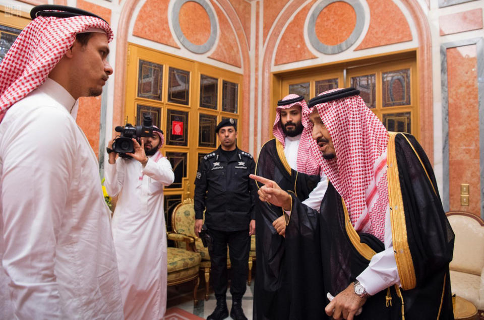 In this photo released by Saudi Press Agency, SPA, Saudi King Salman, right, points to Salah, a son, of Jamal Khashoggi as Crown Prince Mohammed bin Salman, second right, looks on, in Riyadh, Saudi Arabia, Tuesday, Oct. 23, 2018. Saudi Arabia, which for weeks maintained that Jamal Khashoggi had left the Istanbul consulate, on Saturday acknowledged he was killed there in a "fistfight." (Saudi Press Agency via AP)