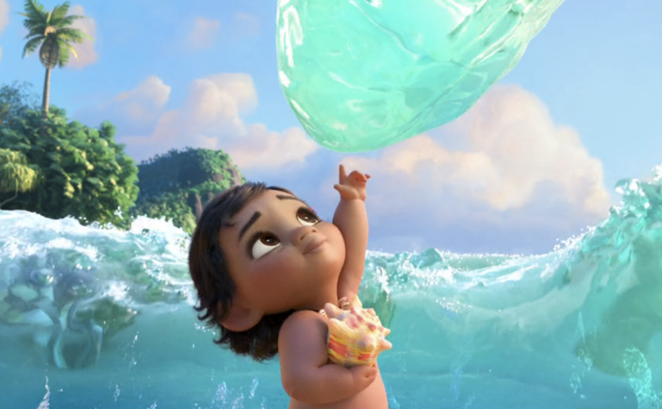 Moana as a baby reaching up to touch a drop of water