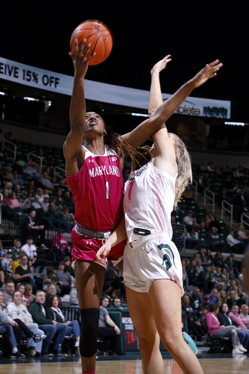 Maryland's Diamond Miller, left, shoots against Michigan State's Tory Ozment during the first half of an NCAA college basketball game, Saturday, Feb. 18, 2023, in East Lansing, Mich. (AP Photo/Al Goldis)