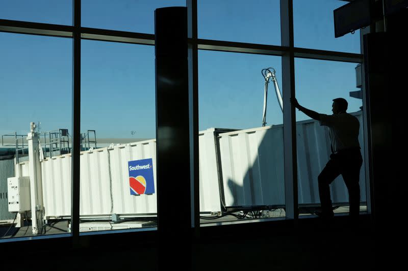 FILE PHOTO: A Southwest pilot talks on his phone as he waits for a plane to arrive at William P. Hobby Airport in Houston, Texas