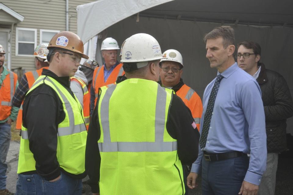 Rep. Frank Mrvan, D-Ind, right, listens to construction workers on Oct. 12, 2022 at the work site near where the new 11th Street Station will be constructed as part of NICTD's Double Track NWI project in Michigan City, Ind. The $491.12 million project will include a second set of tracks from Gary to Michigan City, dramatically reducing commute time to Chicago. (Donovan Barrier/La Porte County Herald-Dispatch via AP)