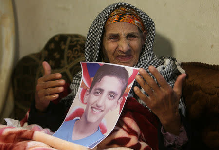 The grandmother of Palestinian boy, Ala Al-Zamli, who was killed at the Israel-Gaza border, weeps as she holds his picture in Rafah in the southern Gaza Strip April 9, 2018. REUTERS/Ibraheem Abu Mustafa