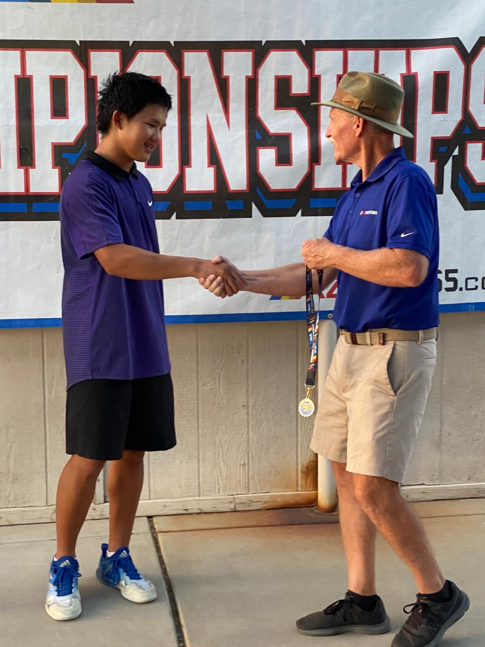 Andrew Yang receives his medal. He became the second player from AZ College Prep to win the Division III Boys Singles title since 2015.