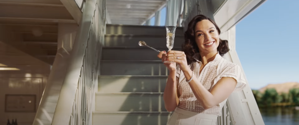 Gal Gadot leads a toast in the movie "Death On The Nile"